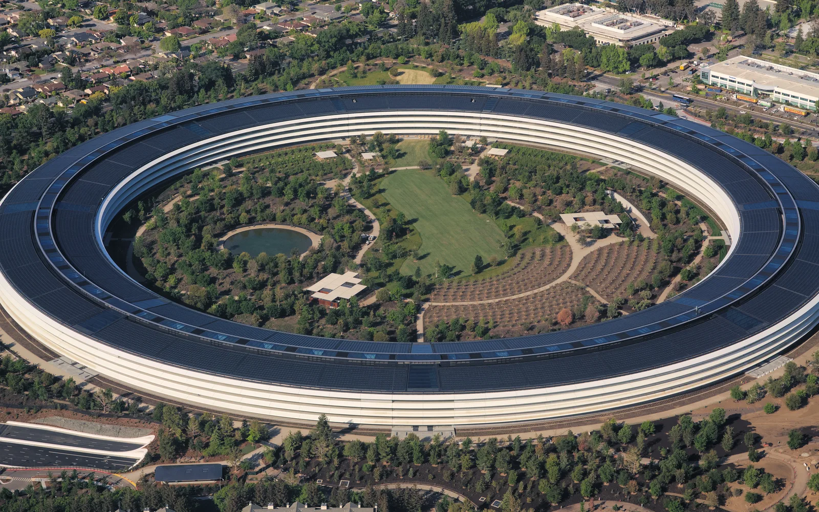 Aerial view of Apple Park showing the circular campus building with solar panels